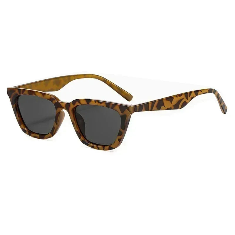Sunglasses with leopard print frame and dark lenses on a white background