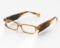 Smart glasses with a translucent amber-brown and black tortoiseshell frame, featuring integrated electronic components on the temples, shown on a clean white background.