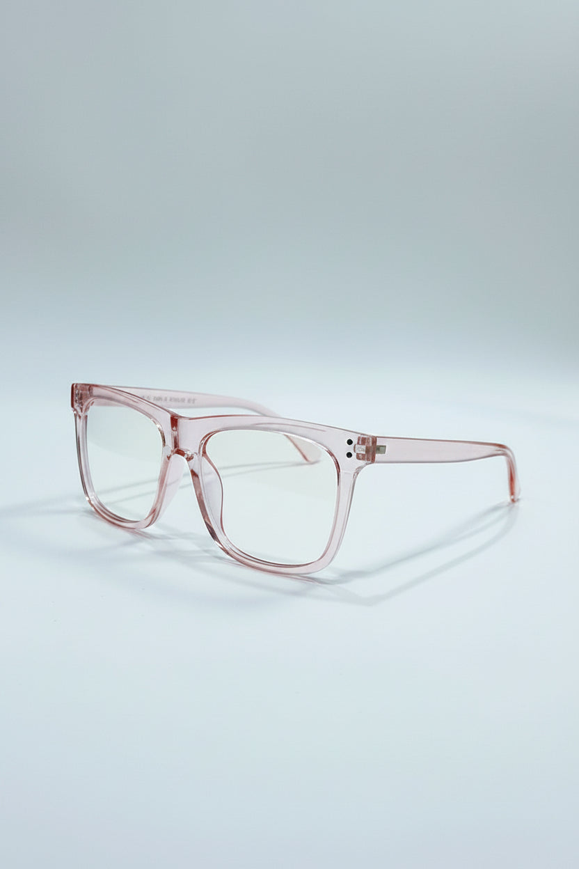 Pink eyeglasses on a silver case with a light gray background